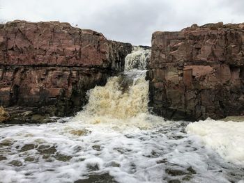 The big sioux river flows over rocks in sioux falls south dakota with views