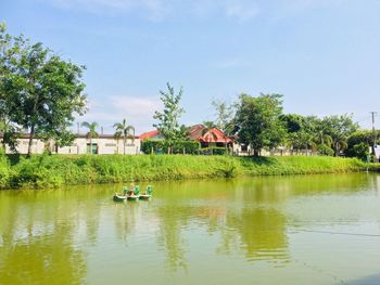 Scenic view of lake by building against sky