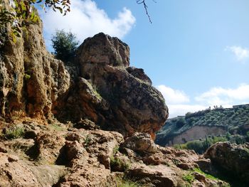 Low angle view of rock formations against sky