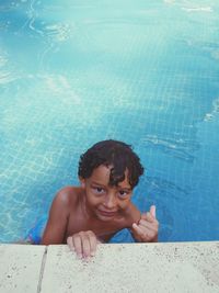 Portrait of shirtless boy swimming in pool