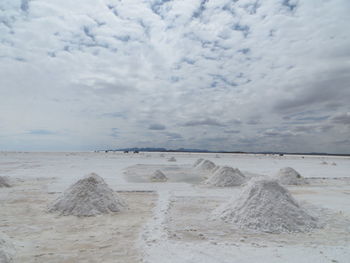 Heap of salt in salar de uyuni against sky