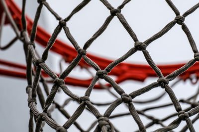 Low angle view of chainlink fence against sky