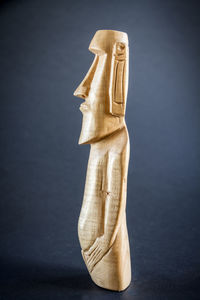 Close-up of sculpture on table against black background