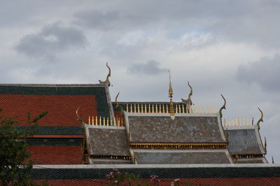 High section of old building against cloudy sky