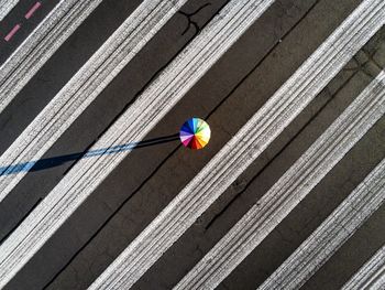 Aerial view of colorful umbrella on road during sunny day