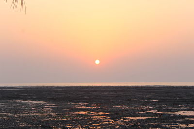 Scenic view of sea against orange sky