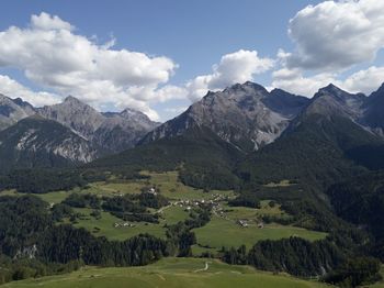 Scenic view of landscape and mountains against sky