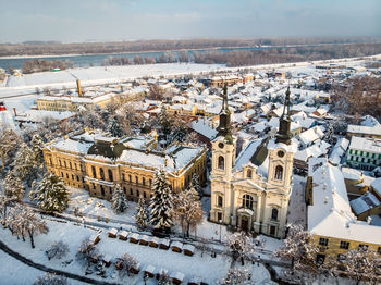 High angle view of snow covered buildings in city