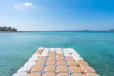 Beautiful tropical beach sea and sand with floating walkway pontoon in andaman sea thailand.