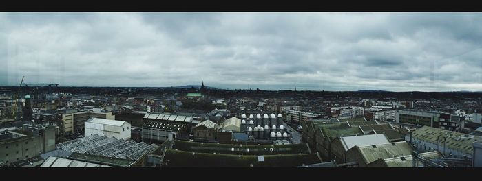 Cityscape against cloudy sky