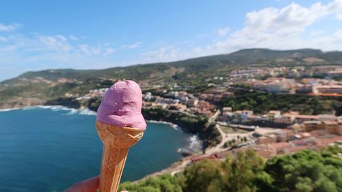 Hand holding ice cream cone