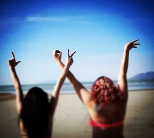 Rear view of two women on the beach