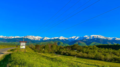 Scenic view of mountains against clear blue sky