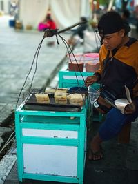 Man selling food at market stall