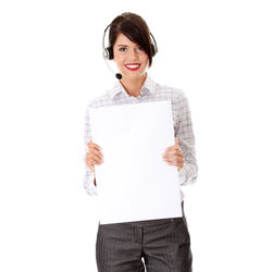Portrait of smiling woman standing against white background