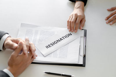 Midsection of woman with text on paper at table