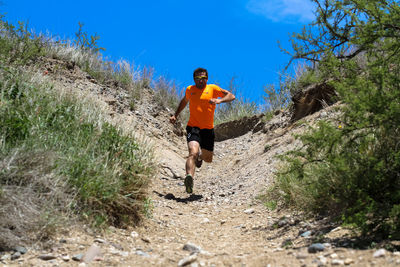 Full length of man running on road