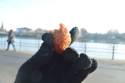 Close-up of hand holding ice cream in river