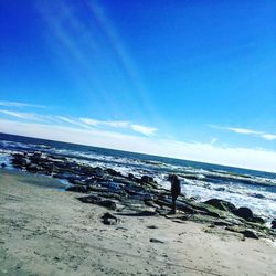 Scenic view of beach against blue sky