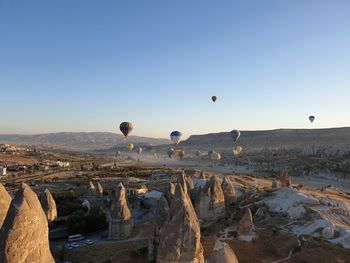 View of hot air balloon flying over rocks