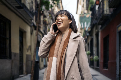 Portrait of a smiling young woman in city