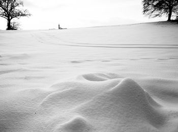 Scenic view of snow covered land against sky