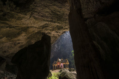 Group of people on rock formation in cave