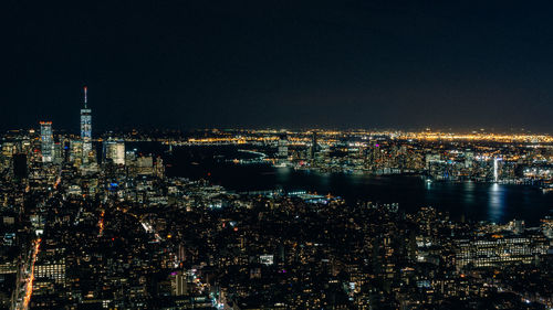 Aerial view of illuminated cityscape against clear sky at night