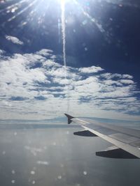 Airplane flying over sea against sky