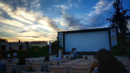 Silhouette of people against cloudy sky