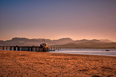 Scenic view of beach against sky during sunset