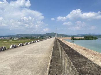 Road by bridge against sky