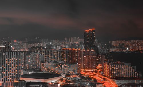 Illuminated cityscape against sky at night