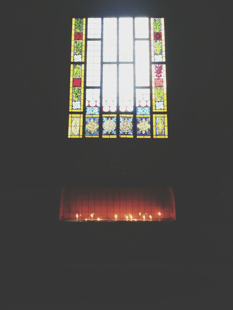 indoors, window, glass - material, architecture, illuminated, built structure, transparent, dark, building exterior, no people, night, communication, text, reflection, multi colored, low angle view, city, western script, building, wall - building feature