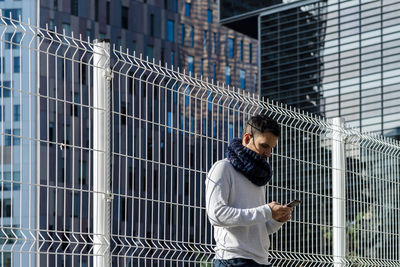 Low angle view of man using mobile phone