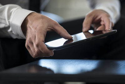 Midsection of man using digital table