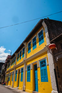 Low angle view of building against blue sky