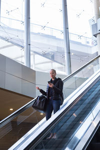 Full length of woman standing on staircase