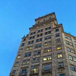 Low angle view of building against blue sky