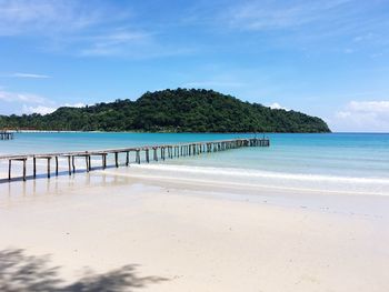 Scenic view of beach against blue sky