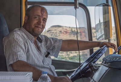 Portrait of man sitting in car