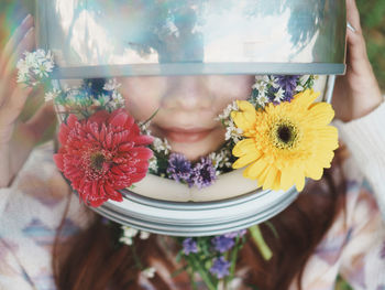 Midsection of woman with flowers