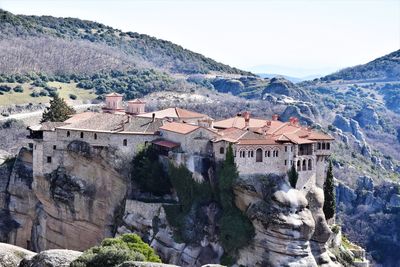 High angle view of buildings and mountains against sky, monastery