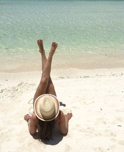 Young woman resting on shore at beach