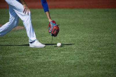 Low section of person playing with ball on grass