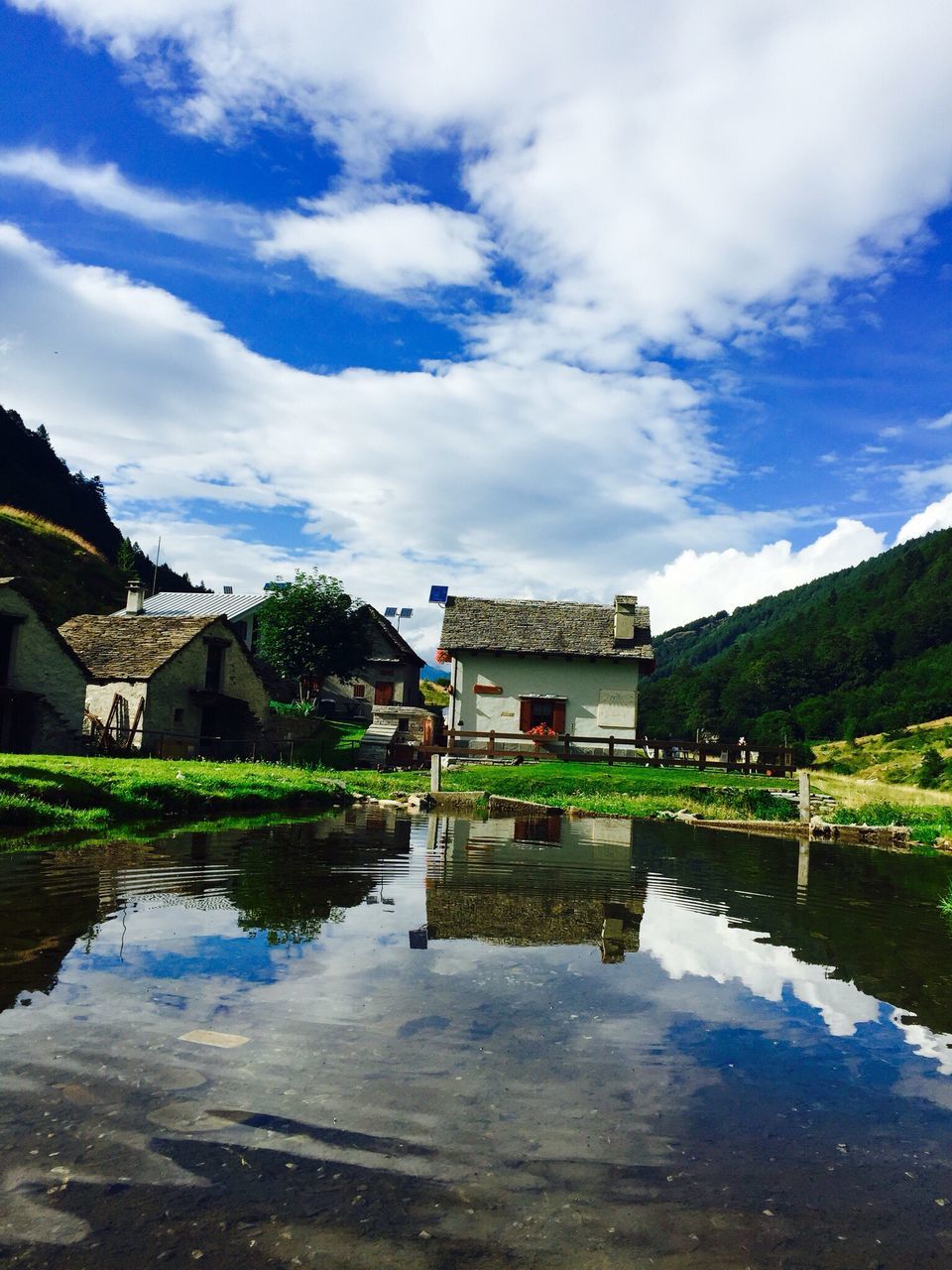 water, sky, reflection, cloud - sky, architecture, built structure, building exterior, outdoors, nature, no people, day, tree, beauty in nature