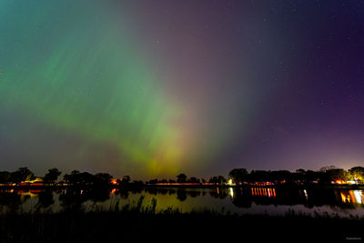 High angle view of illuminated buildings against sky at night