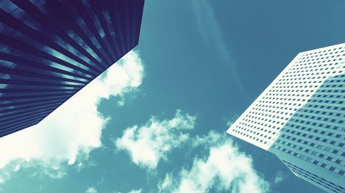 Low angle view of modern building against blue sky