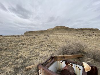 Abandoned truck on field against sky