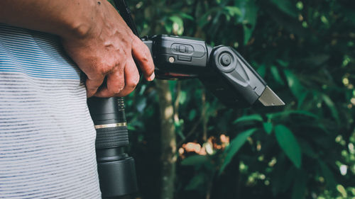 Midsection of man photographing camera